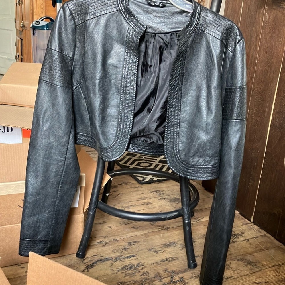 Black waist length jacket leather style says it is a large, but runs small